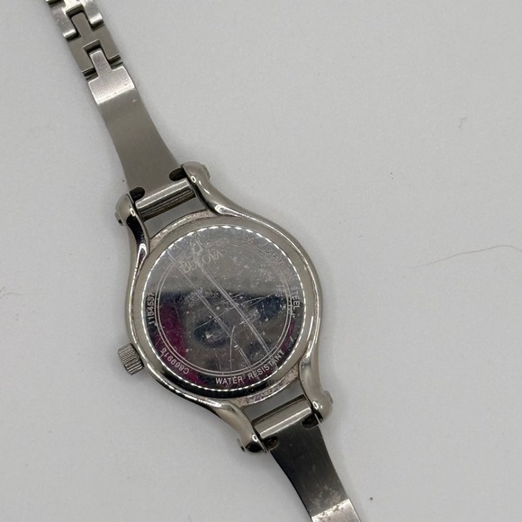 Bulova Women Silver Tone Crystal Bezel White Dial Bangle Watch C869915 READ